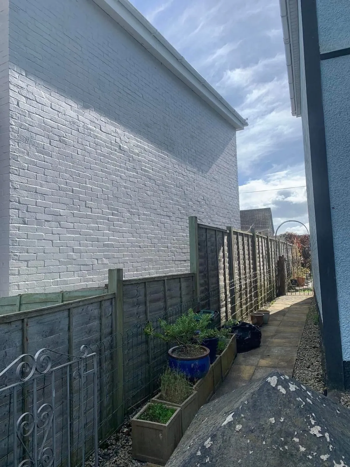Freshly painted brick wall after preparation and masonry paint in Barnstaple