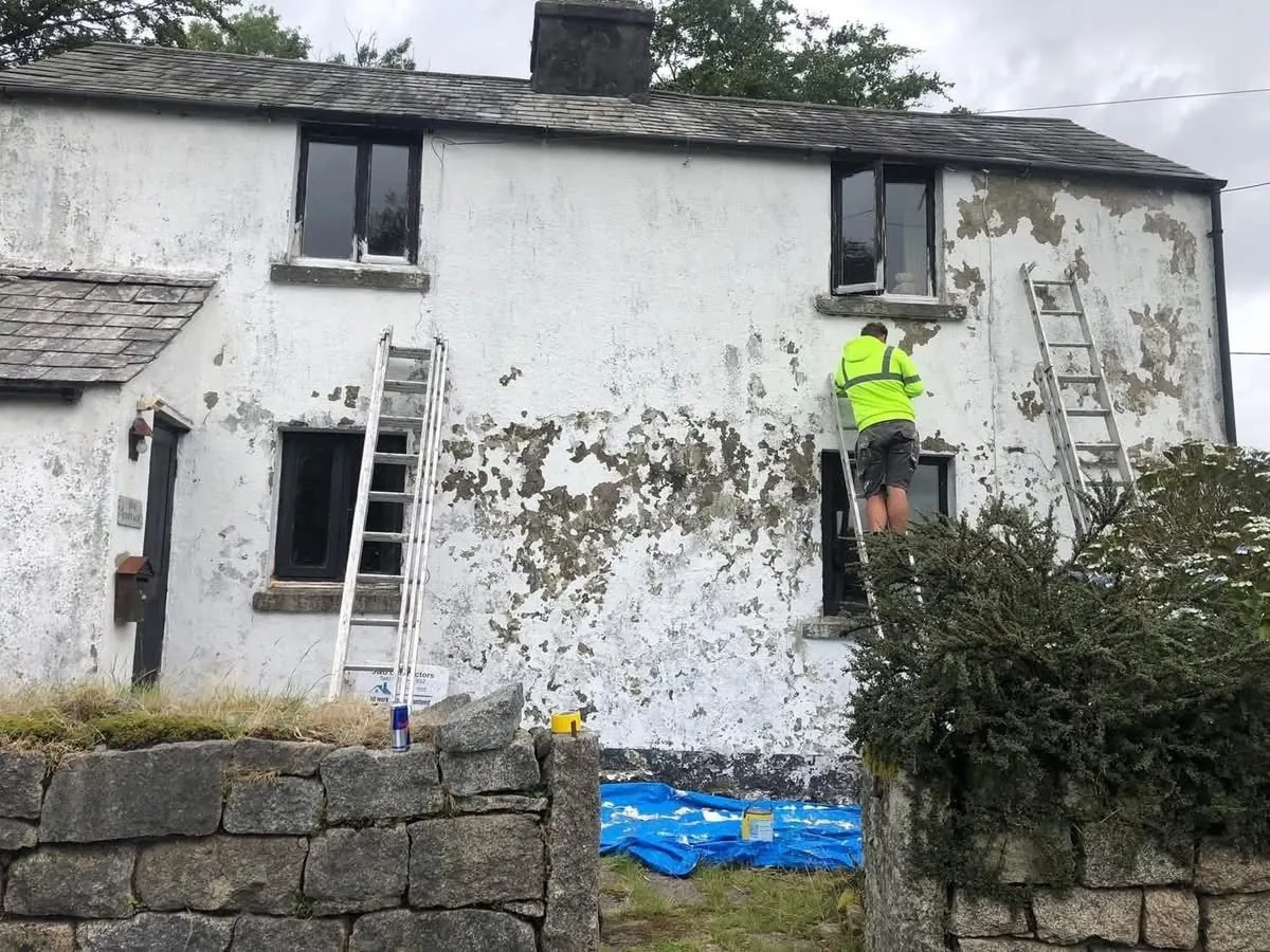 Cottage with blown, flaking render before repair in Barnstaple